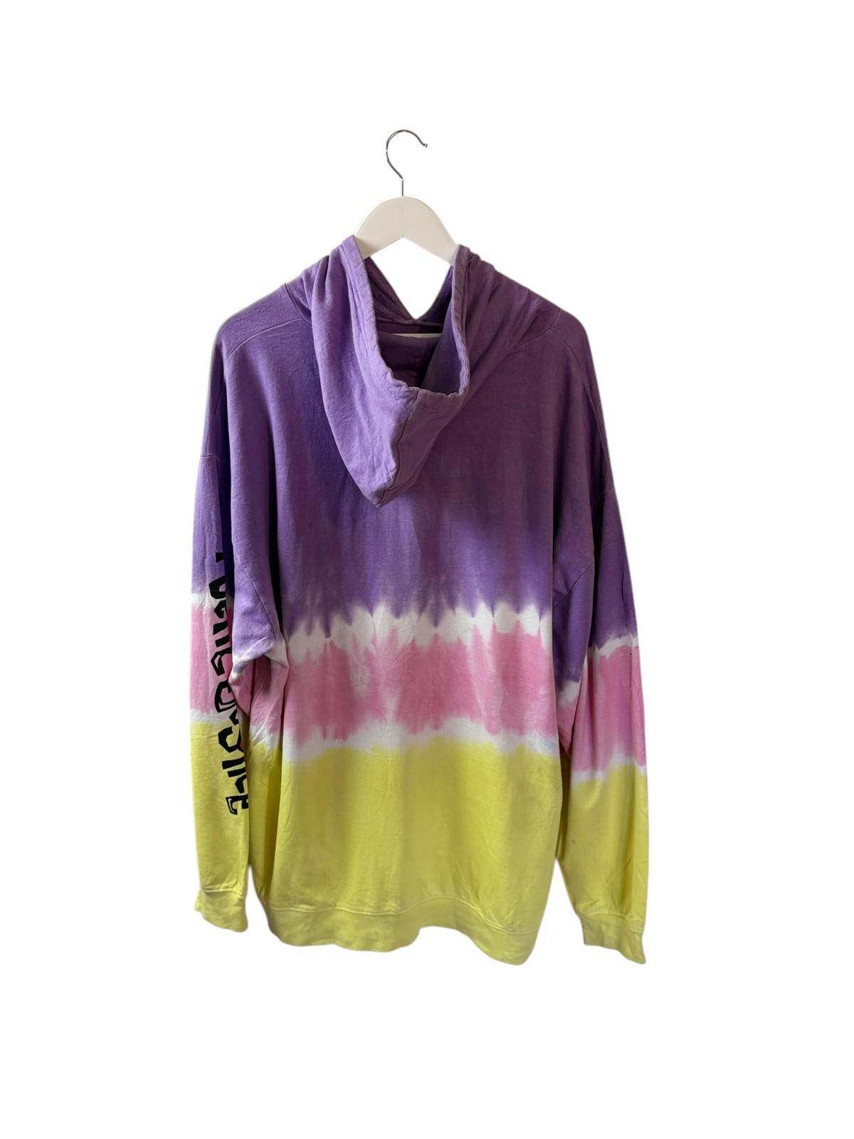 Colorful tie-dye hoodie on a hanger with a white background