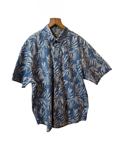 Blue patterned shirt on a wooden hanger against a white background