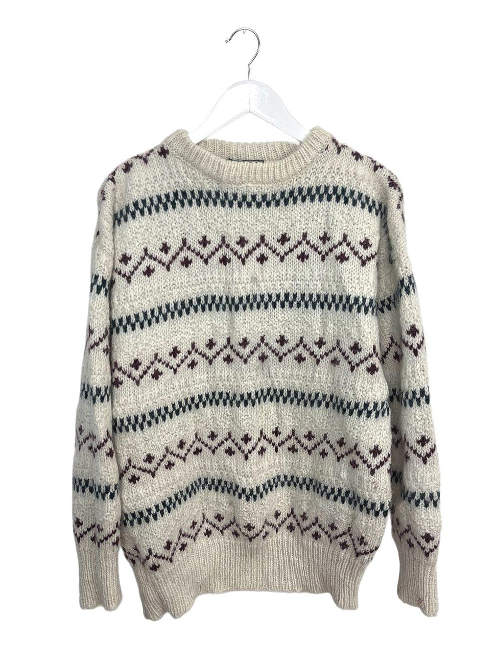 Beige sweater with black pattern on a white background