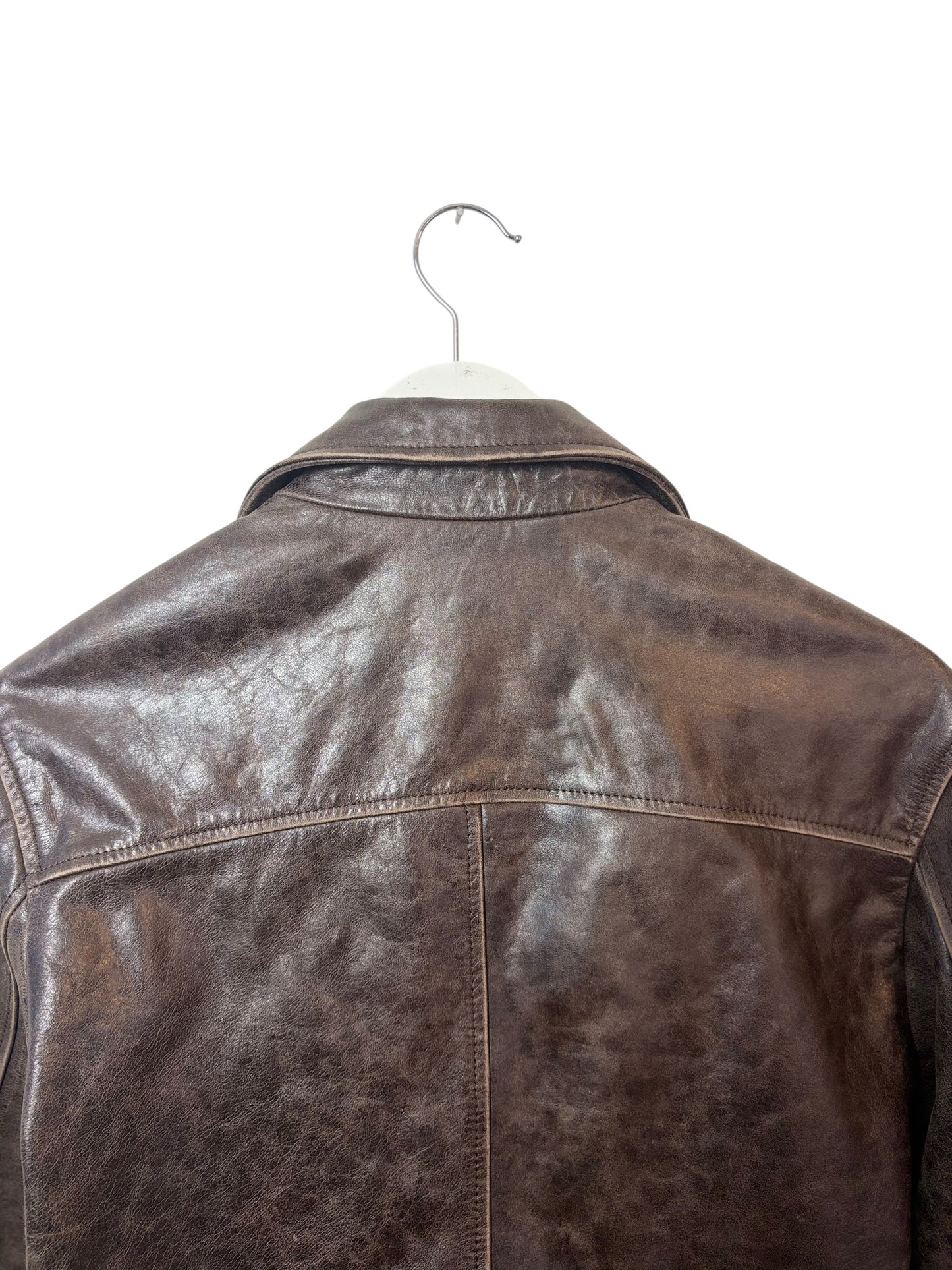 The back of a brown leather jacket on a white background vintage