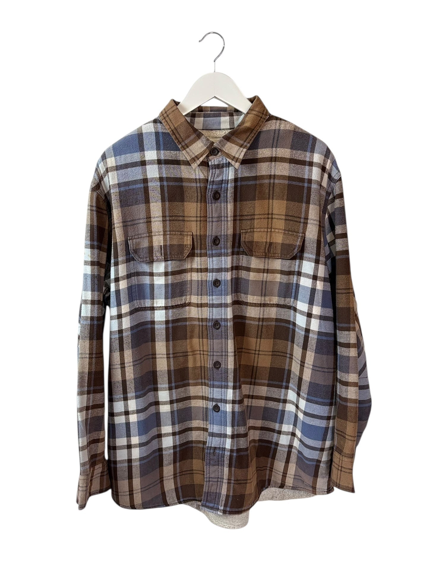 tan brown plaid flannel shirt on white hanger
