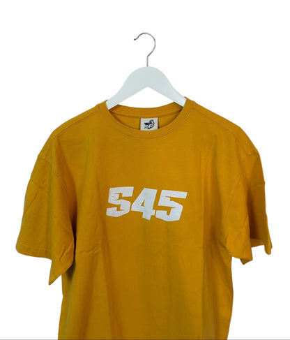 Mustard yellow t-shirt with '545' printed on it, hanging on a white hanger against a white background.