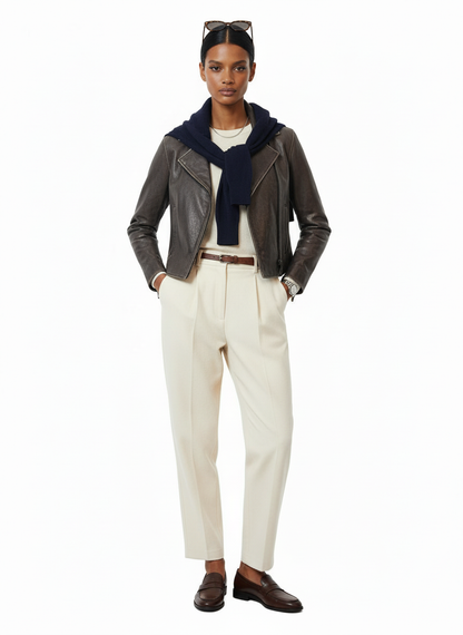 Women wearing brown leather jacket white rousers with sun glasses on a white background