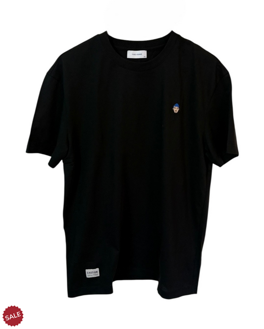 Black graphic tee featuring a cool face cartoon blend of minimalism and intrigue. Crafted from a soft cotton-nylon blend