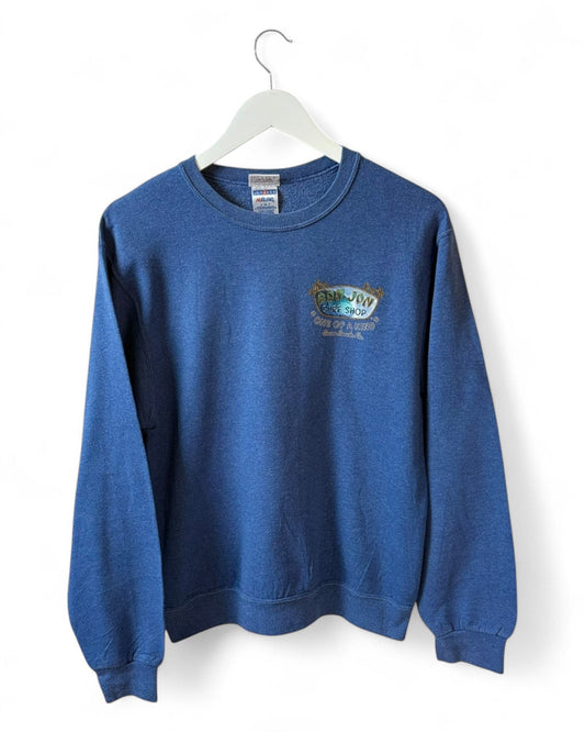 DESCRIPTION

Faded ocean-blue Ron Jon Surf Shop tee with small left chest print 